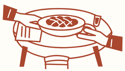 Hands sharing a plate of bread around a table